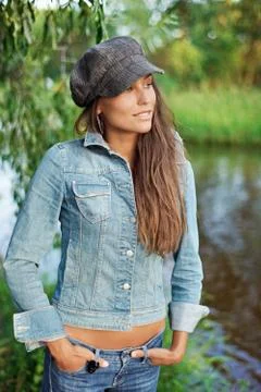 Attractive young woman dressed in jean jacket and beret Stock Photos