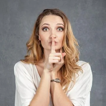 The woman is wearing adult diapers. Urinary incontinence problem. Finger on  lips - silent gesture. Stock Photo