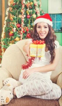 Attractive young woman giving gift box with red bow Stock Photos