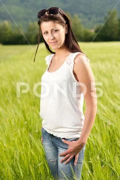 Attractive young woman on grain field Stock Photos