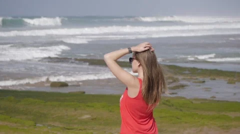 Attractive young woman looking on sea waves Stock Footage 59790542