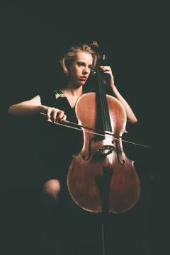 Attractive young woman playing the cello Stock Photos