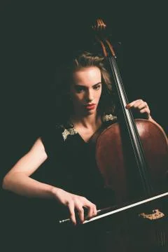 Attractive young woman playing a cello Stock Photos