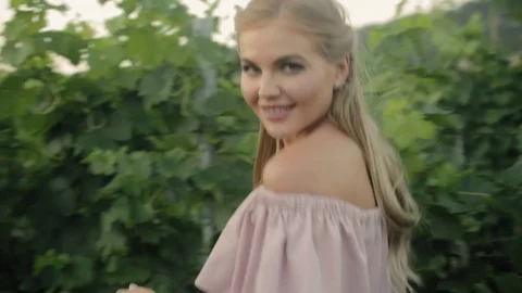 Attractive young woman posing while walking in vineyards Stock Footage 80947366