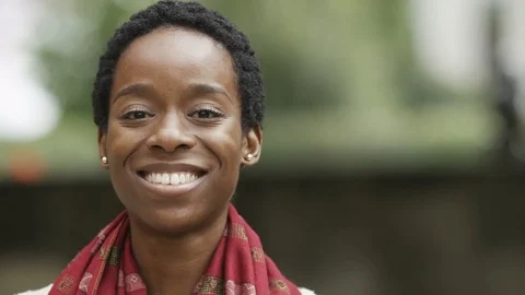 Attractive young woman smiles to camera Stock Footage 80322053