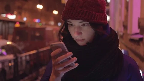 Attractive young woman smiling using smartphone in a crowded street Stock Footage 83080119