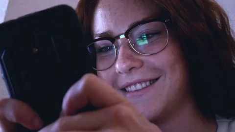 Attractive young woman using Iphone smartphone texting glasses reflection Stock Footage 77865115