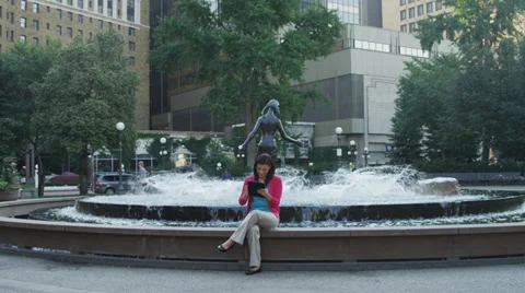 Attractive Young Woman Using Tablet By Fountain Stock Footage 37181068