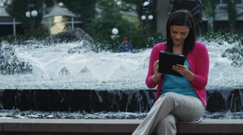 Attractive Young Woman Using Tablet By Fountain Stock Footage 37181086