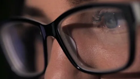 Attractive young woman using tablet touchscreen. Reflection of tablet in glasses Video stock 69788053