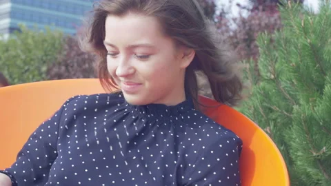 Attractive young woman using a tablet computer while relaxing in the park Stock Footage 133044708