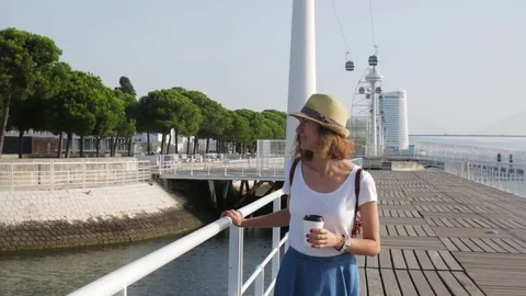 Attractive young woman walking in Lisbon near Tajus river at Park of the Nations Video stock 77172853