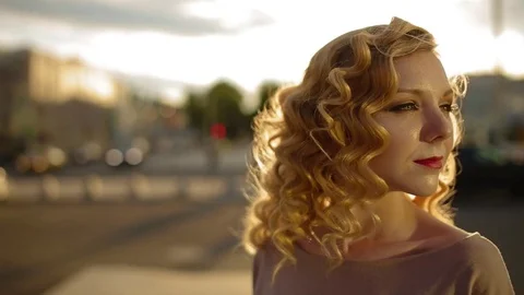 Attractive young woman with white curly hair daylight city on background. Stock Footage
