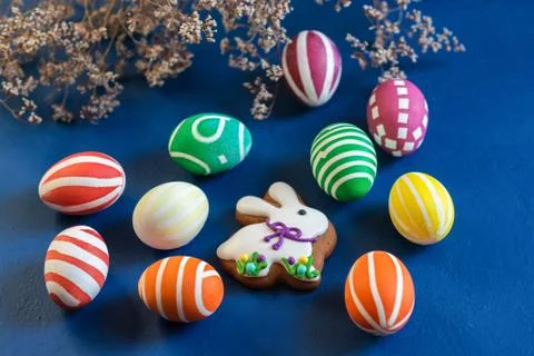 The attributes of the chrestian Easter holiday are colored eggs and gingerbre Stock Photos