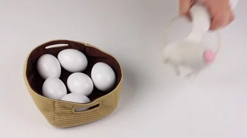 Attributes of Easter - eggs and mask of rabbit, human hand picks up the mask Video stock 85509022