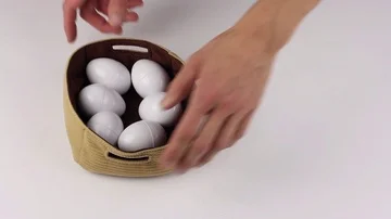 Attributes Easter - eggs and rabbit mask, human hands takes basket with eggs Видео 85509342