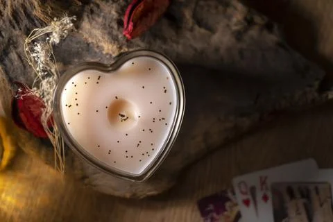 Attributes for love magic and fortune telling on cards, a candle on a wooden Stock Photos