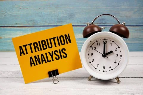 Attribution Analysis text written on paper card with alarm clock on wooden .. Stock Photos