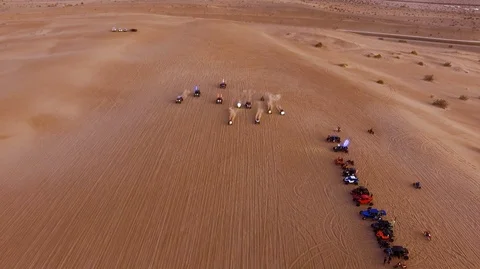 ATV and dune buggies race to the finish in the desert Stock Footage 99158490