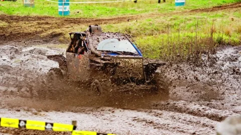 ATV completes muddy loop trailing dirt on forest course Stock Footage 309085366