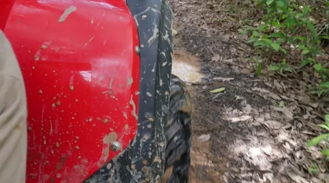 ATV drive through mud puddle Stock Footage 64331047