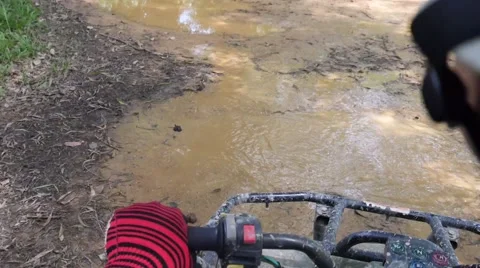 ATV drive through mud puddle Stock Footage 64331068