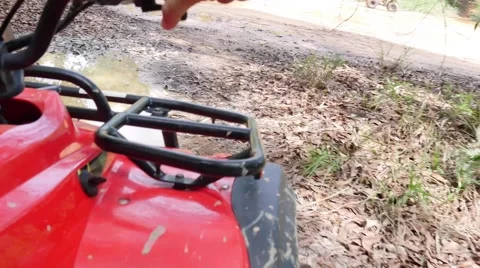 ATV drive through mud puddle Stock Footage 64331070