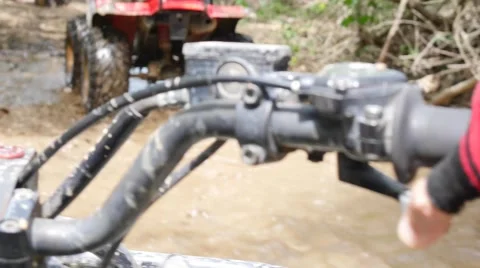 ATV drive through mud puddle Stock Footage 64331083