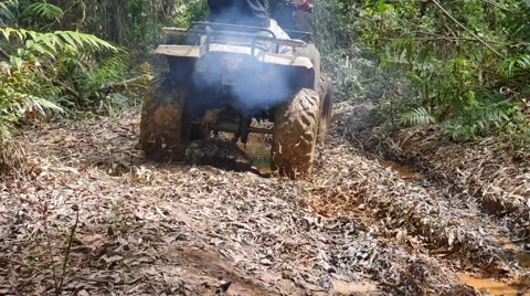 ATV drive through mud puddle Stock Footage 64331157