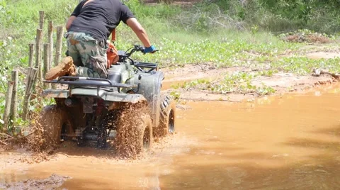 ATV drive through mud puddle Stock Footage 64331232