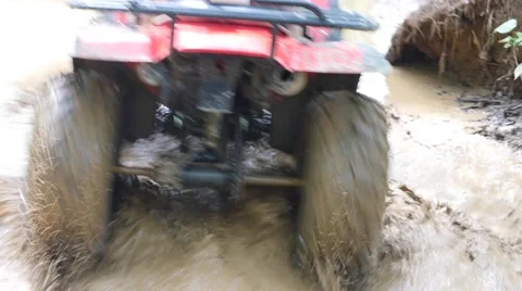 ATV drive through mud puddle Stock Footage 64331274