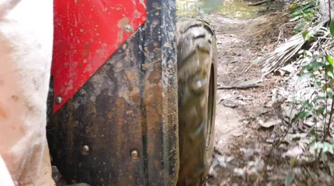 ATV drive through mud puddle Stock Footage 64331357