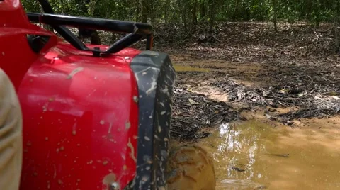 ATV drive through mud puddle Stock Footage 64331366