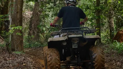 ATV drive through mud puddle Stock Footage 64331399