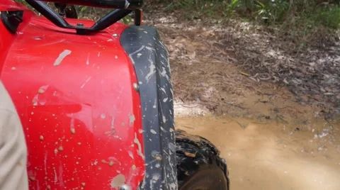 ATV drive through mud puddle Stock Footage 64331450