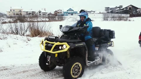 ATV driver is trying to pull the car up a hill Stock Footage 161178089