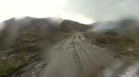ATV driving dirt road in rain mountain trail HD 012 Stock Footage 11968767