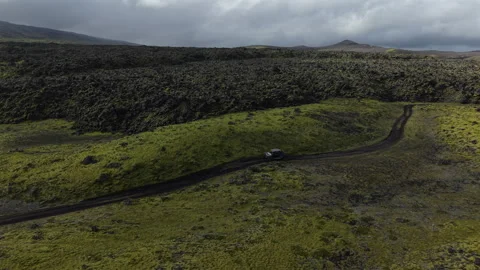 ATV Driving through Moss Covered Lava Fields Iceland Aerial View Stock Footage 324906492