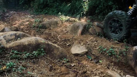 ATV going up a trail full of rocks Stock Footage 82869518
