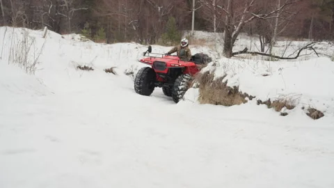 ATV navigates snow. Quad rips through icy terrain. Offroad vehicle cuts across Video stock 345144361