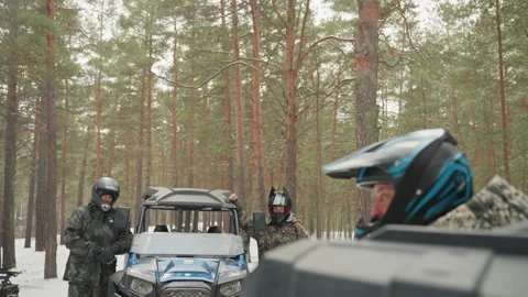 ATV prepares for adventure. Closeup captures rider smiling behind visor. Snowy Stock Footage 334784530