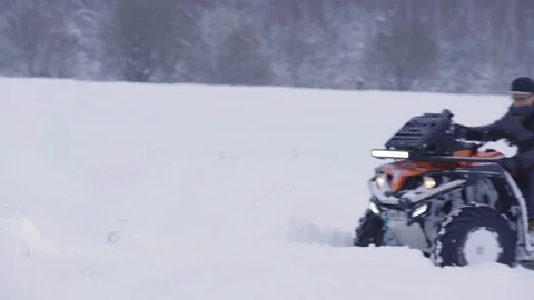 ATV riding in the snow Stock Footage 100994797