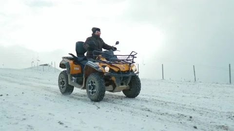 ATV riding in the snow in mountains. Winter road tracks automobile Stock Footage 144355528