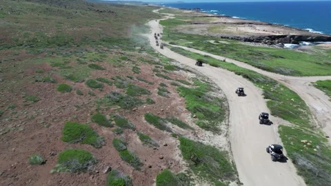 ATV Riding Through Green Coastal Landscape, Aruba Aerial View Video stock 340925655