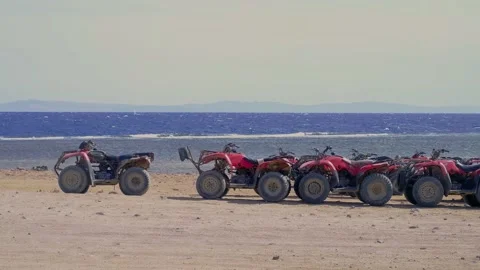 Atv by the sea, red ATVs stand by the sea, ride ATVs by the sea, red sea, atv sa 스톡 동영상 236571293