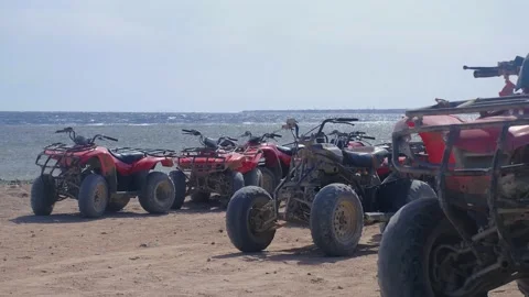 Atv by the sea, red ATVs stand by the sea, ride ATVs by the sea, red sea, atv sa 動画素材 236571650