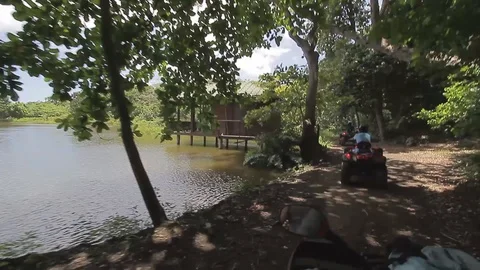 ATV Tours with a pond on the background Stock Footage 88225221