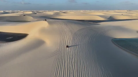 ATVs Crossing Rippled White Sand Between Lagoons in Lençóis Maranhenses Stock Footage 342446250