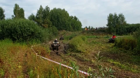 ATVs go through the mud in off-road race Stock Footage 189584229