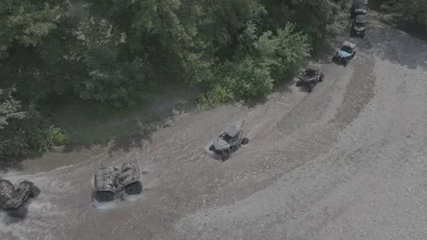 ATVs Ride Through Muddy Terrain in Forest with Drone Aerial View Stock Footage 341903840